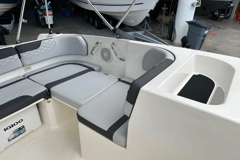 Slide: The Image of 2023 Bayliner M17 boat interior with gray seating and storage compartment. - 12