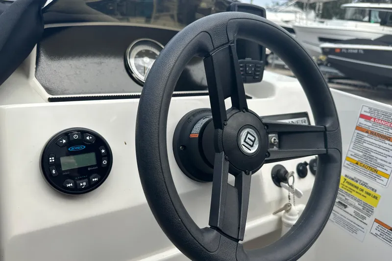 Slide: The Image of 2023 Bayliner Element M17 steering wheel and dashboard controls. - 14
