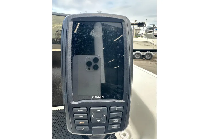 Slide: The Image of Garmin device on 2023 Bayliner Element M17 boat dashboard, outdoor setting. - 17