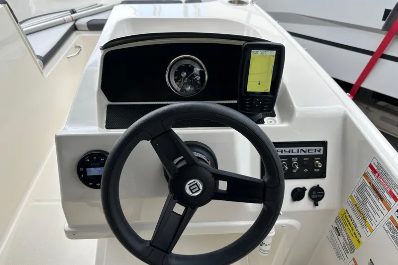 Slide: The Image of 2023 Bayliner M17 boat dashboard with steering wheel and navigation display. - 20