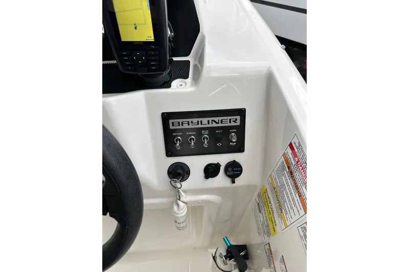 Slide: The Image of 2023 Bayliner M17 boat dashboard with controls and navigation system. - 21