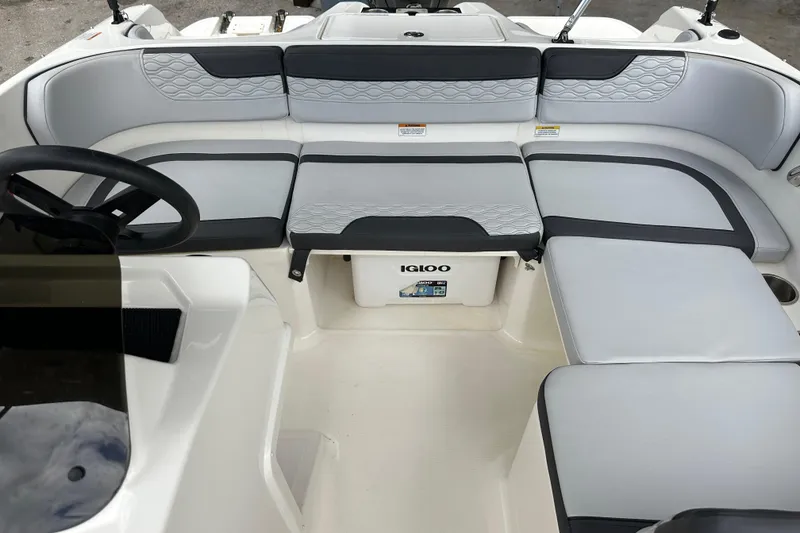 Slide: The Image of 2023 Bayliner M17 boat interior with gray seating and Igloo cooler. - 22