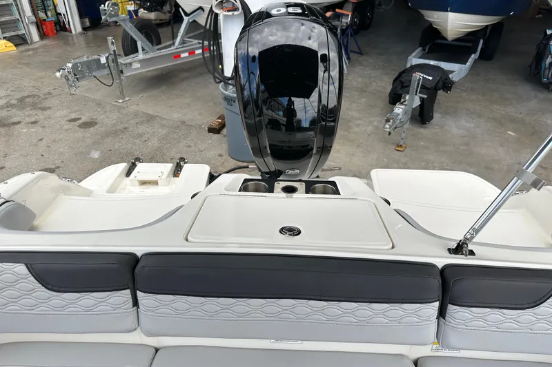 Slide: The Image of 2023 Bayliner M17 boat interior with motor, in a garage setting. - 23