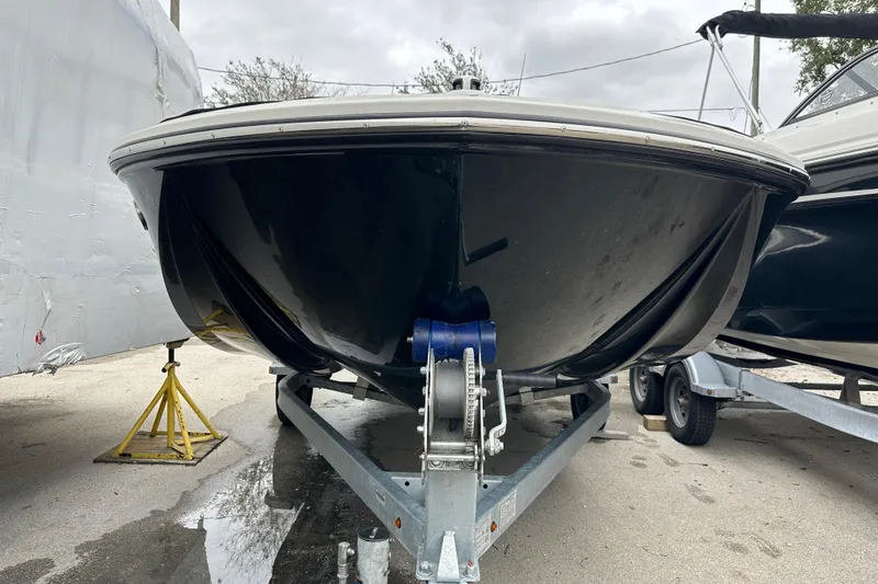 Slide: The Image of 2023 Bayliner Element M17 boat on trailer, front view, parked outdoors. - 3