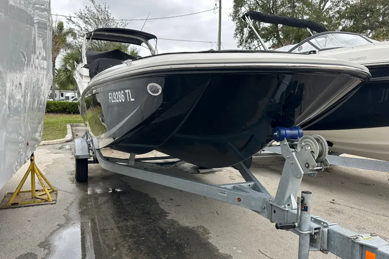Slide: The Image of 2023 Bayliner Element M17 boat on trailer, parked outdoors. - 4