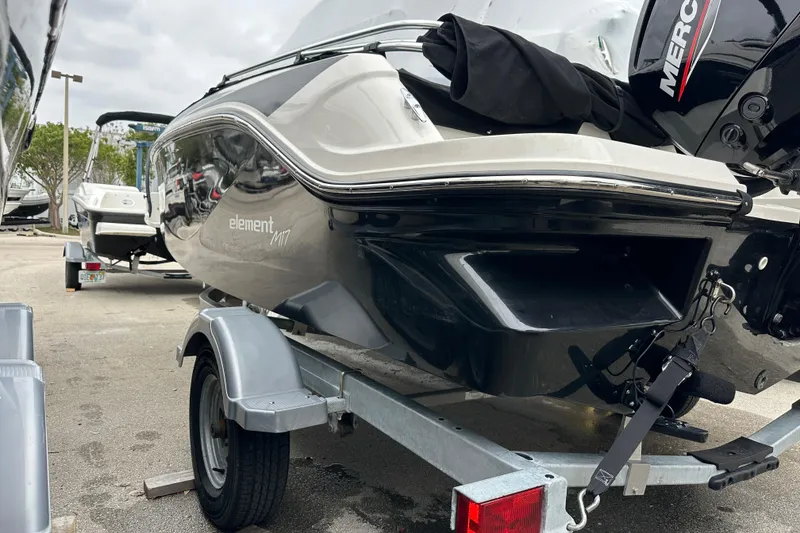 Slide: The Image of 2023 Bayliner Element M17 boat on trailer, rear view with Mercury engine. - 5
