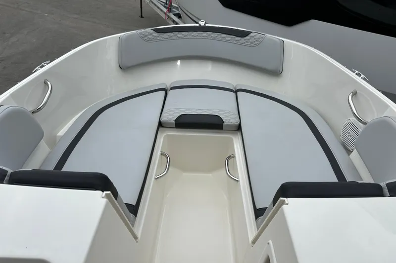 Slide: The Image of 2023 Bayliner M17 boat interior with gray seating and stainless steel handles. - 9