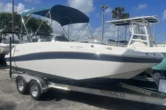 The Image of 2022 Hurricane SunDeck Sport 192 RL OB boat on trailer, under blue sky. - 1