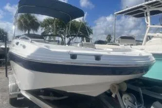 Slide: The Image of 2022 Hurricane SunDeck Sport 192 RL OB boat with canopy, docked under blue sky. - 3