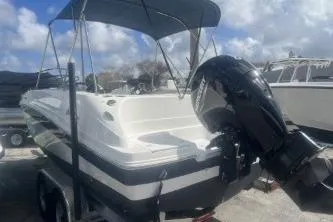 Slide: The Image of 2022 Hurricane SunDeck Sport 192 RL OB boat with outboard motor and canopy. - 5