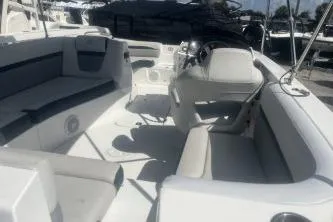 Slide: The Image of 2022 Hurricane SunDeck Sport 192 RL OB boat interior with seating and steering console. - 6