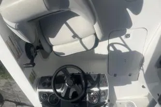 Slide: The Image of 2022 Hurricane SunDeck Sport 192 RL OB boat cockpit with steering wheel and seating. - 7