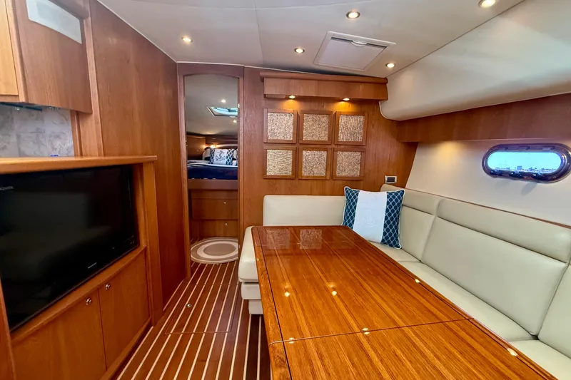 Slide: The Image of Luxurious interior of 2012 Tiara Yachts 4500 Sovran with wood finishes and seating area. - 10