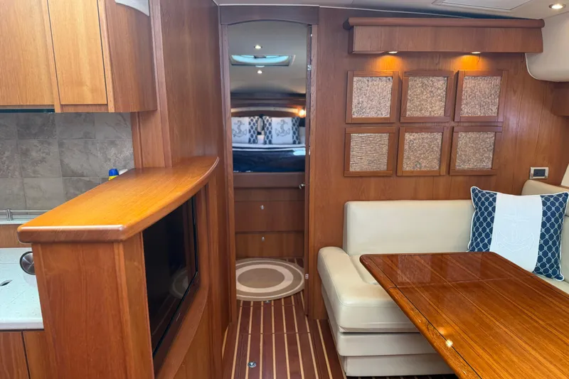 Slide: The Image of Luxurious interior of 2012 Tiara Yachts 4500 Sovran with wood finishes and cozy seating. - 12