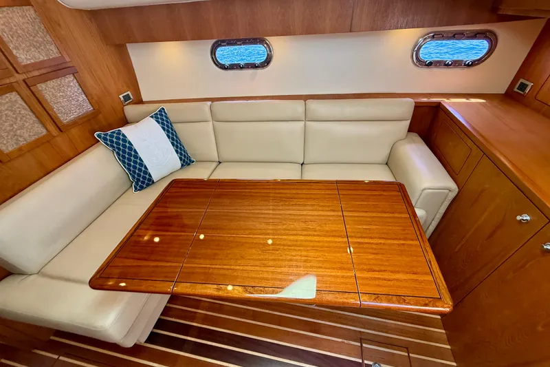 Slide: The Image of Luxurious interior of 2012 Tiara Yachts 4500 Sovran with elegant seating and wooden table. - 13