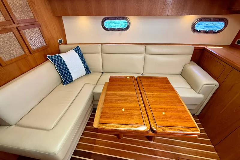 Slide: The Image of Luxurious interior of 2012 Tiara Yachts 4500 Sovran with leather seating and wooden table. - 14