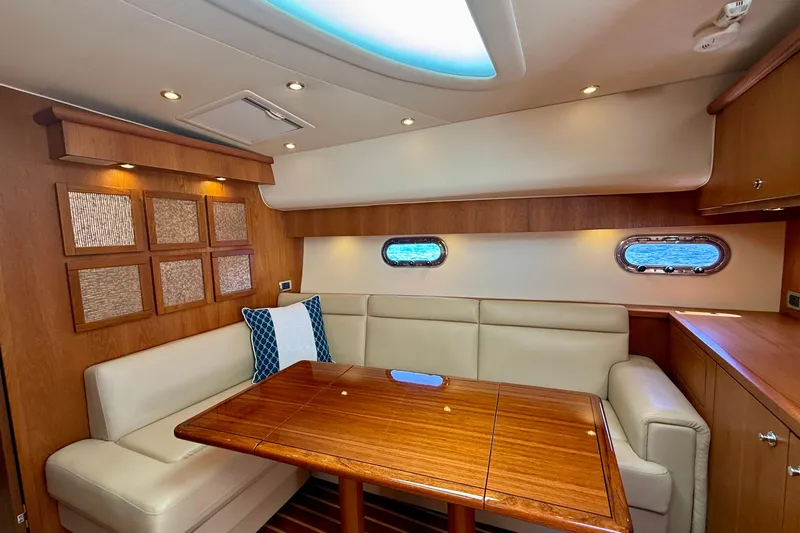 Slide: The Image of Luxurious interior of 2012 Tiara Yachts 4500 Sovran with elegant seating and wooden table. - 15