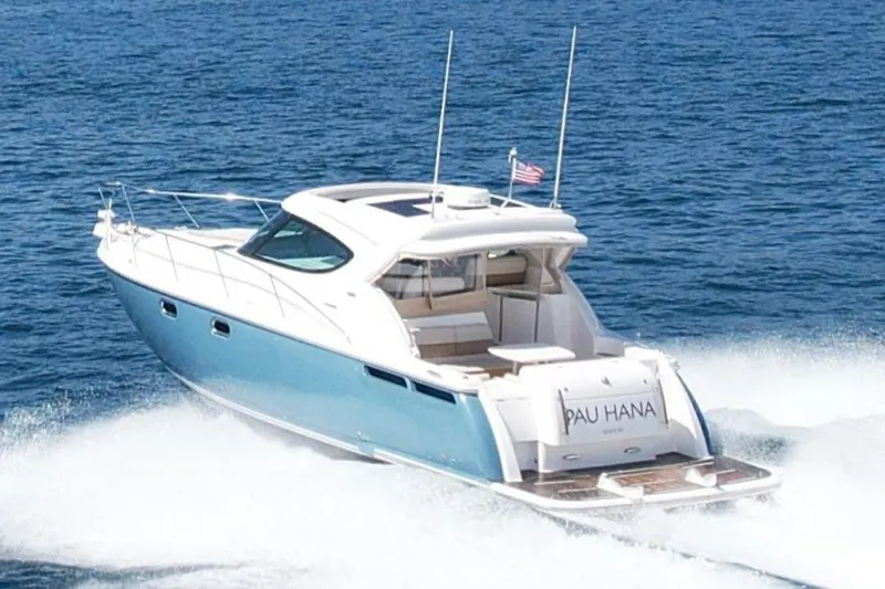 Slide: The Image of 2012 Tiara Yachts 4500 Sovran cruising on open water, rear view. - 2