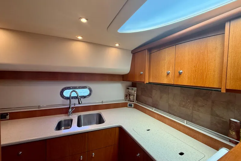 Slide: The Image of Luxurious kitchen interior of 2012 Tiara Yachts 4500 Sovran with wooden cabinets and modern fixtures. - 23