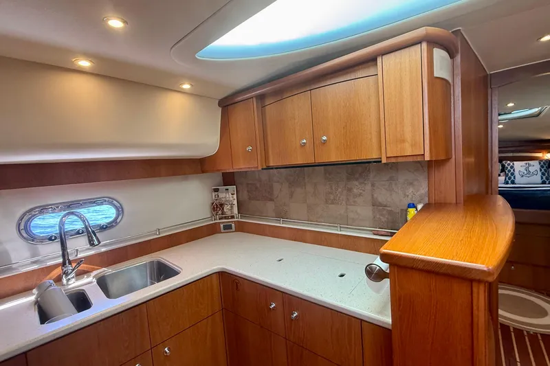 Slide: The Image of Luxurious 2012 Tiara Yachts 4500 Sovran kitchen with wood cabinetry and modern fixtures. - 29