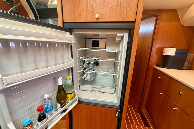 Slide: The Image of Open fridge in 2012 Tiara Yachts 4500 Sovran galley with beverages inside. - 30