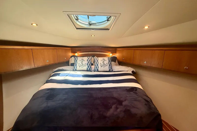 Slide: The Image of Luxurious cabin interior of 2012 Tiara Yachts 4500 Sovran with nautical-themed bedding. - 32