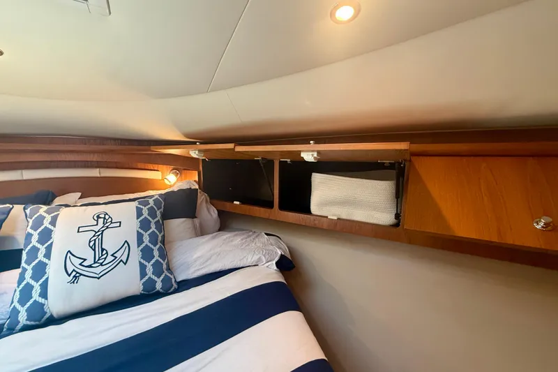 Slide: The Image of Interior cabin of 2012 Tiara Yachts 4500 Sovran with nautical-themed bedding. - 35