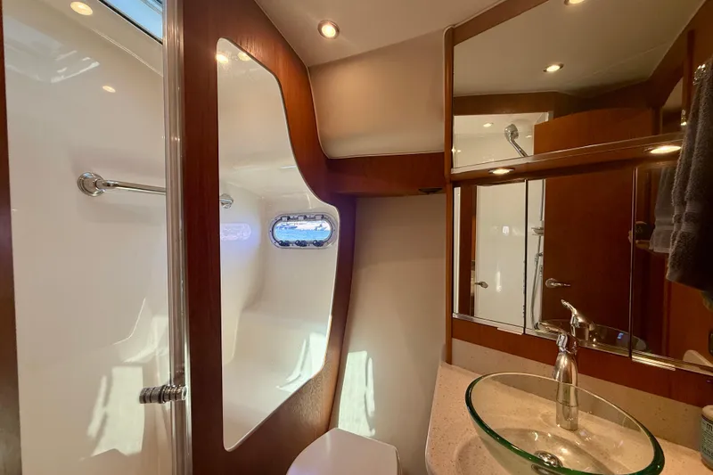 Slide: The Image of Luxurious bathroom interior of 2012 Tiara Yachts 4500 Sovran with modern fixtures and wood accents. - 38