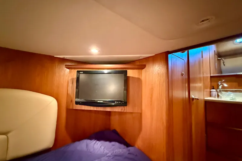 Slide: The Image of Luxurious cabin interior of 2012 Tiara Yachts 4500 Sovran with TV and wooden finish. - 42