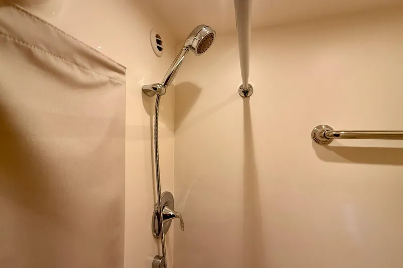 Slide: The Image of Shower area in 2012 Tiara Yachts 4500 Sovran, featuring chrome fixtures and curtain. - 45