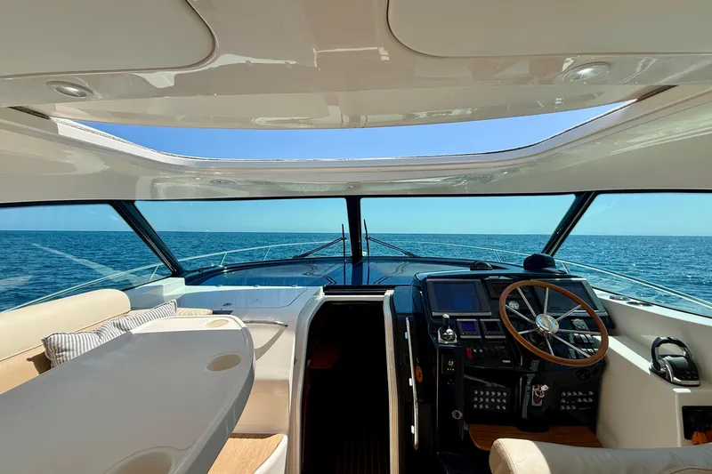 Slide: The Image of Interior view of 2012 Tiara Yachts 4500 Sovran, showcasing helm and ocean horizon. - 54