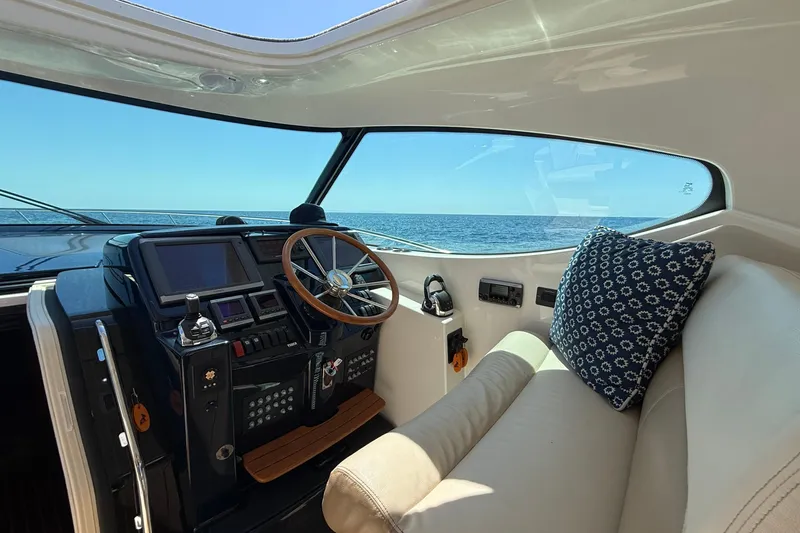 Slide: The Image of Helm of 2012 Tiara Yachts 4500 Sovran with ocean view and plush seating. - 55