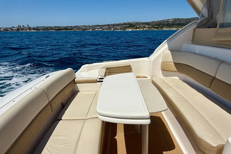 Slide: The Image of Luxurious seating area on 2012 Tiara Yachts 4500 Sovran, overlooking serene ocean waters. - 59