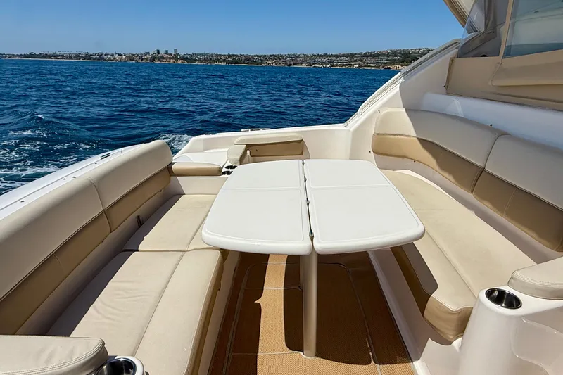 Slide: The Image of Luxurious seating area on 2012 Tiara Yachts 4500 Sovran, overlooking serene ocean waters. - 60