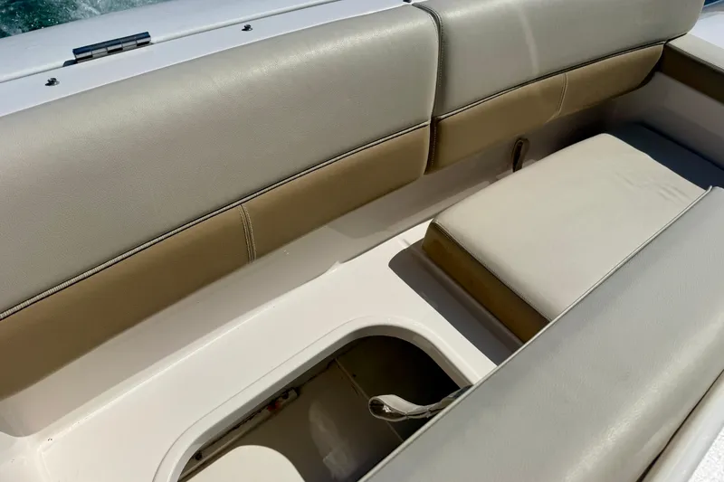 Slide: The Image of Interior seating of 2012 Tiara Yachts 4500 Sovran, featuring beige upholstery and storage compartment. - 69