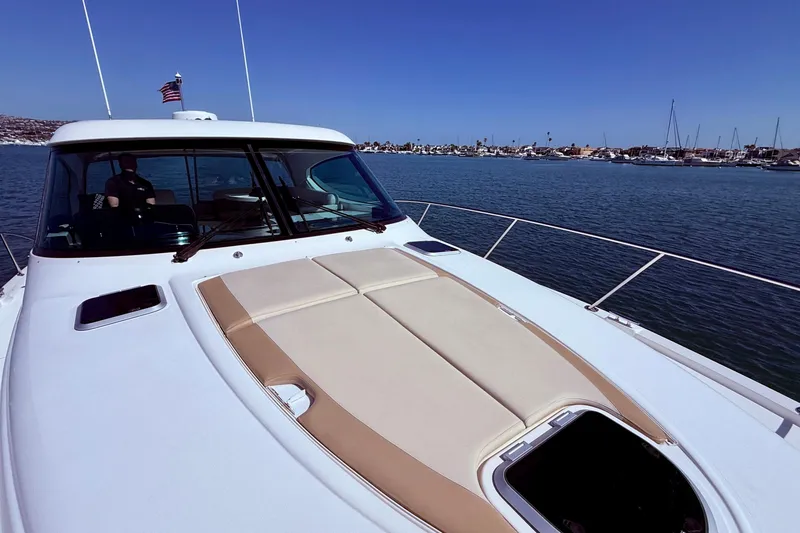 Slide: The Image of 2012 Tiara Yachts 4500 Sovran cruising on calm waters with clear blue sky. - 73