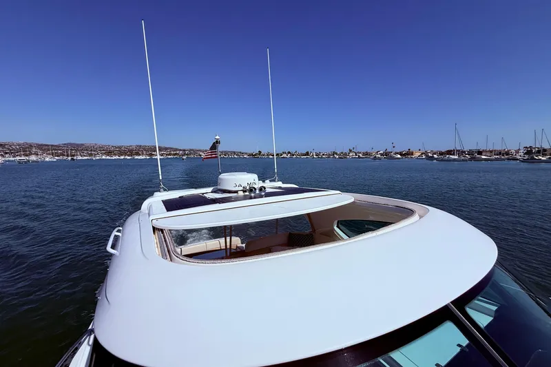 Slide: The Image of 2012 Tiara Yachts 4500 Sovran cruising in a scenic harbor under clear blue skies. - 74