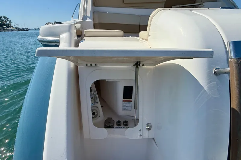Slide: The Image of 2012 Tiara Yachts 4500 Sovran yacht stern with open storage compartment by the water. - 76