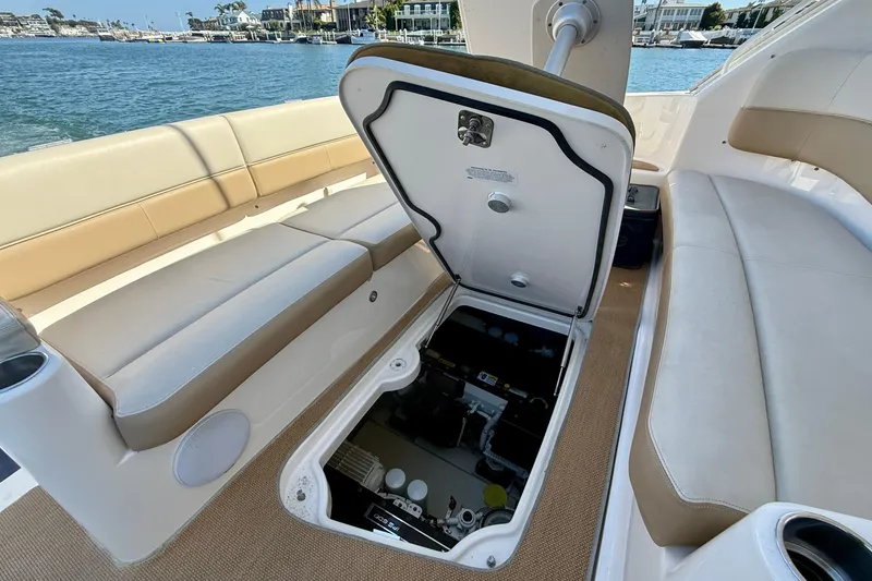 Slide: The Image of 2012 Tiara Yachts 4500 Sovran with open engine compartment, docked by the water. - 78