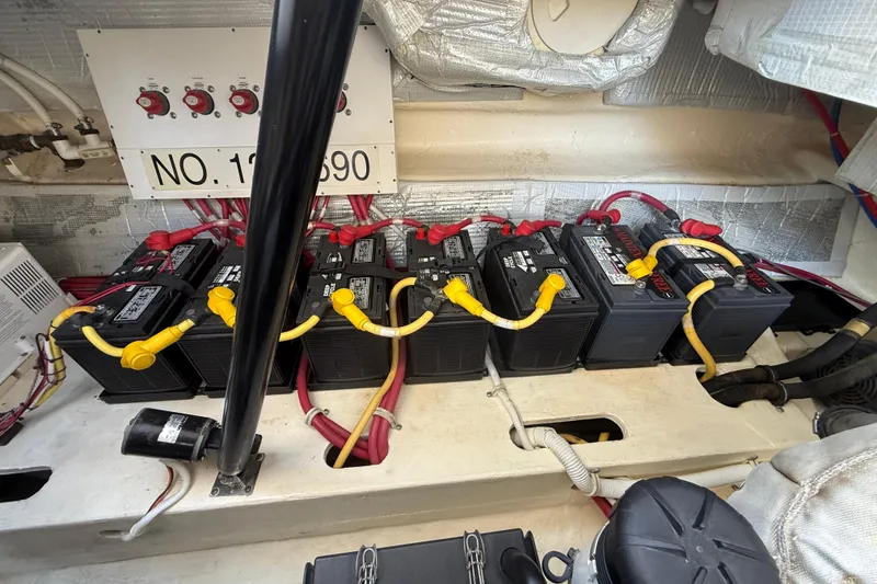 Slide: The Image of Battery compartment of a 2012 Tiara Yachts 4500 Sovran with multiple batteries and wiring. - 83