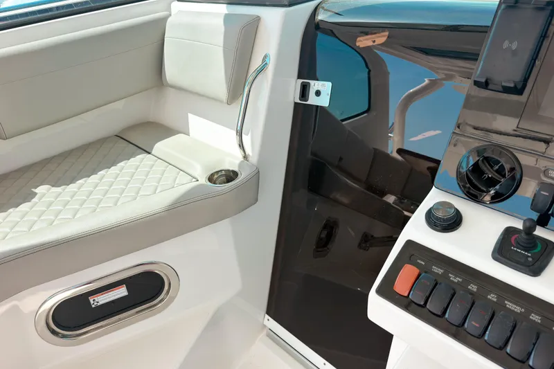 Slide: The Image of 2025 Pursuit OS 325 Offshore cockpit with seating and control panel. - 10