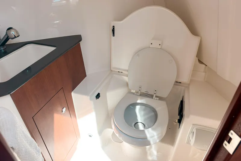 Slide: The Image of 2025 Pursuit OS 325 Offshore boat bathroom with sink and toilet. - 17