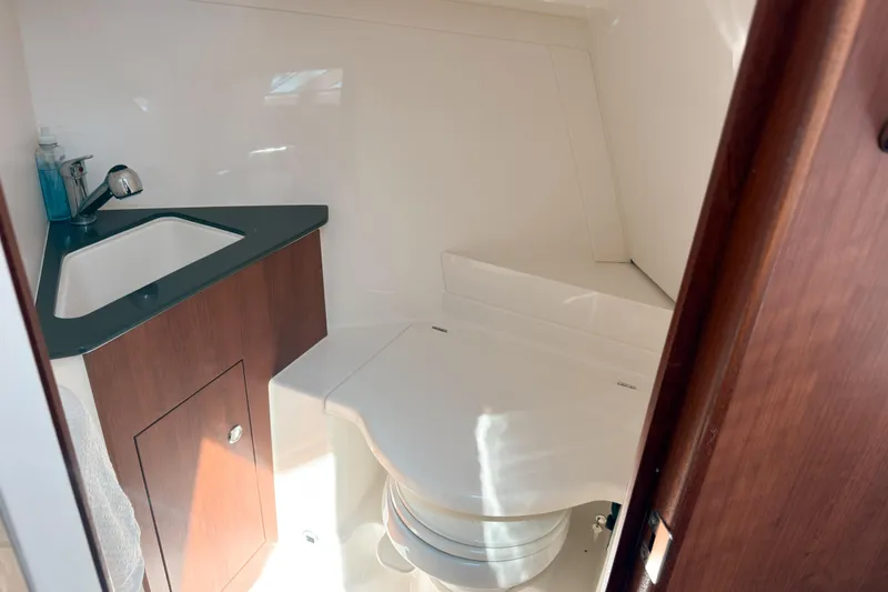 Slide: The Image of 2025 Pursuit OS 325 Offshore boat bathroom with sink and toilet. - 18