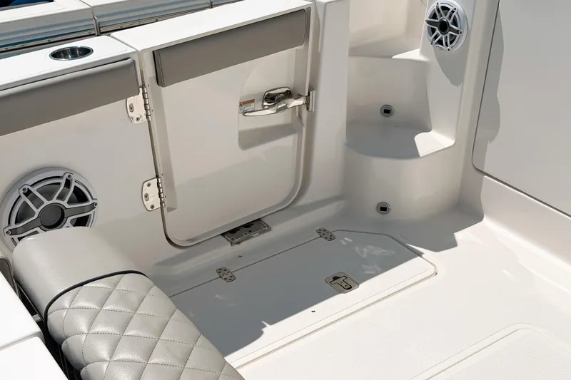 Slide: The Image of Interior view of 2025 Pursuit OS 325 Offshore boat, featuring seating and speaker system. - 19