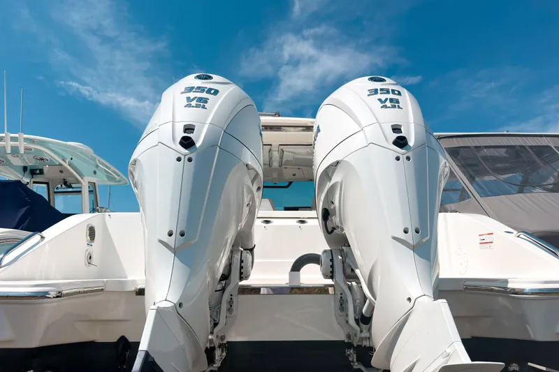Slide: The Image of 2025 Pursuit OS 325 Offshore boat with dual 350 V8 engines under a clear blue sky. - 3