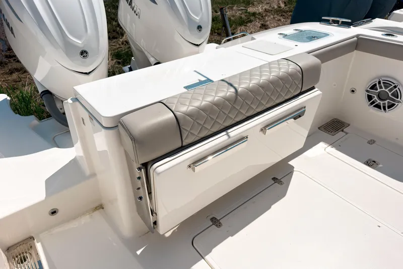 Slide: The Image of 2025 Pursuit OS 325 Offshore boat interior with cushioned seating and storage compartments. - 5
