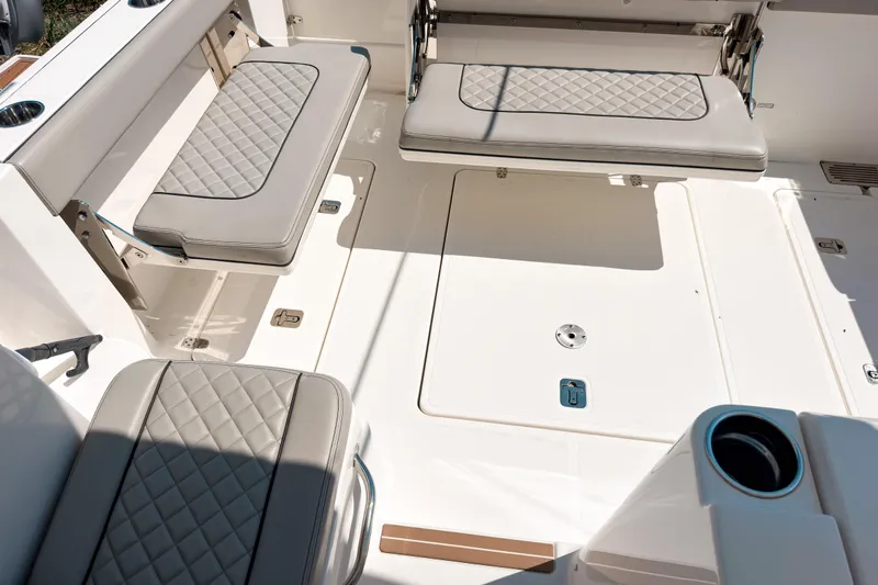 Slide: The Image of 2025 Pursuit OS 325 Offshore boat interior with cushioned seating and storage compartments. - 6