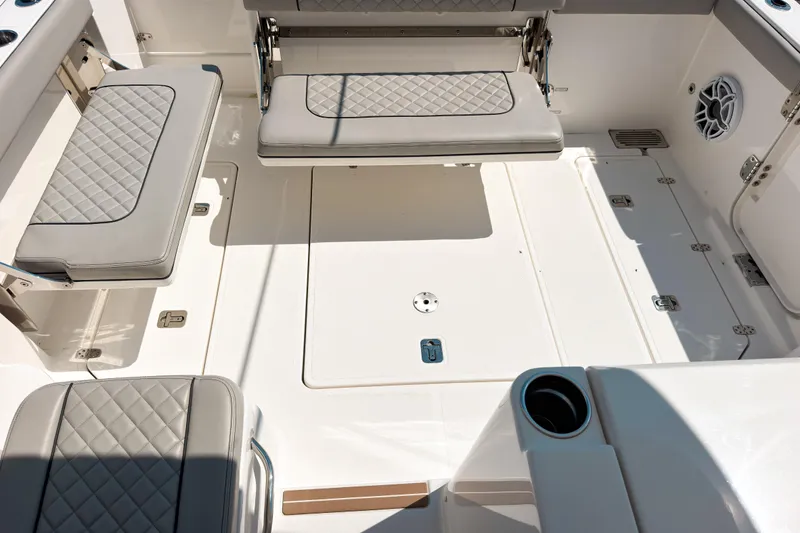 Slide: The Image of 2025 Pursuit OS 325 Offshore boat interior with cushioned seating and storage compartments. - 7