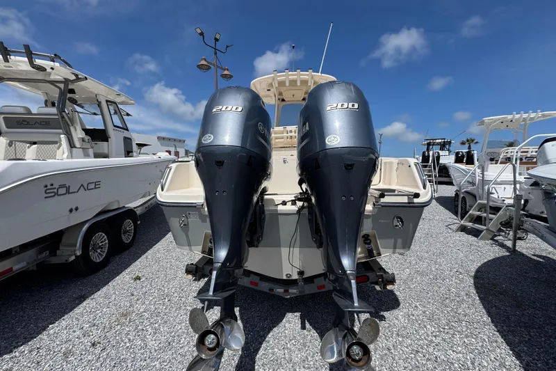Slide: The Image of 2022 Grady-White Fisherman 257 boat with dual Yamaha 200 engines, parked on gravel. - 10