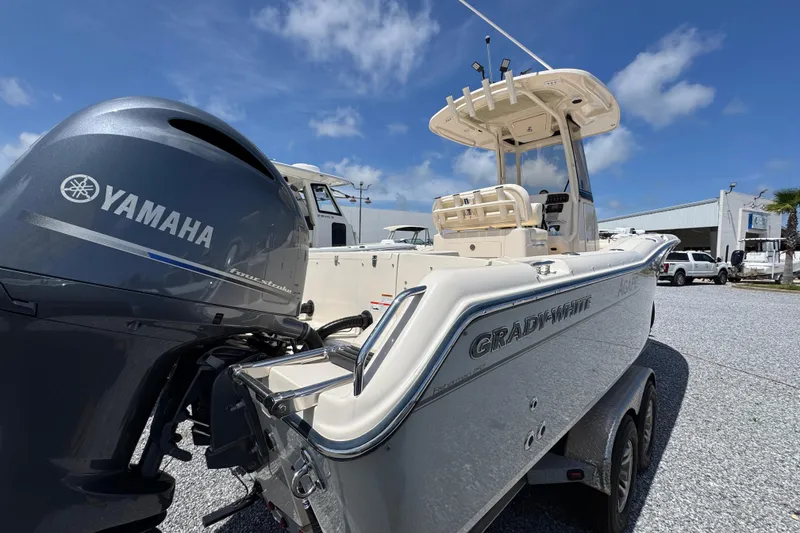 Slide: The Image of 2022 Grady-White Fisherman 257 boat with Yamaha engine, parked outdoors under blue sky. - 12